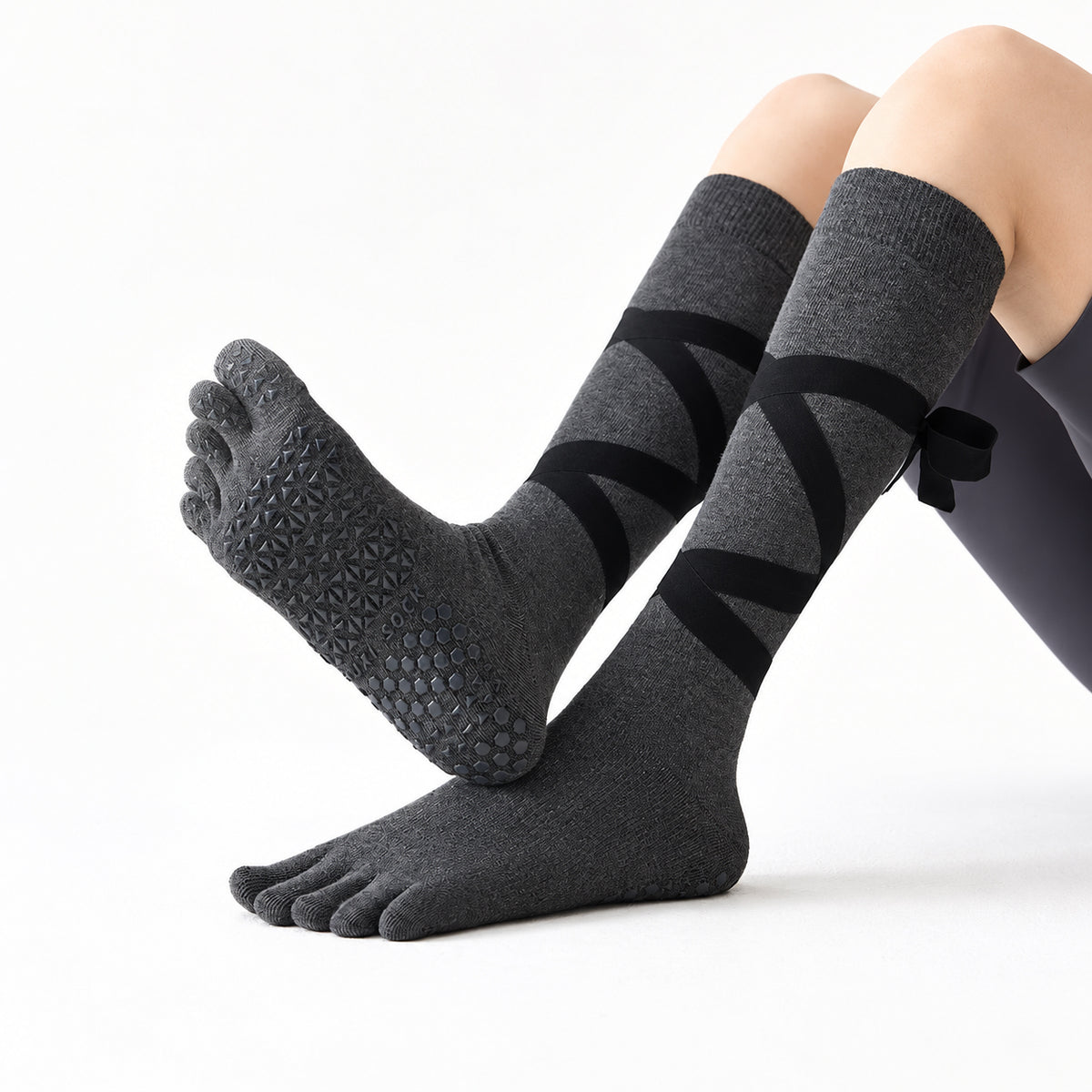 Non-slip, strappy, over-the-calf toe socks for yoga and Pilates.