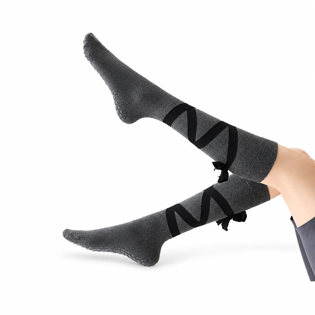 Non-slip, strappy, over-the-calf toe socks for yoga and Pilates.