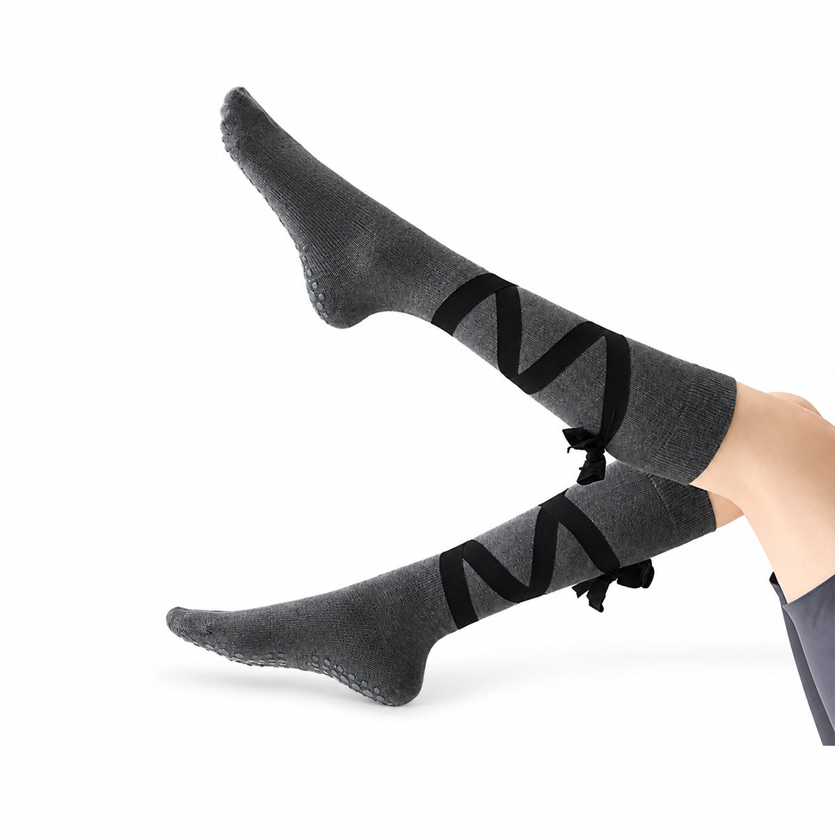 Non-slip, strappy, over-the-calf toe socks for yoga and Pilates.