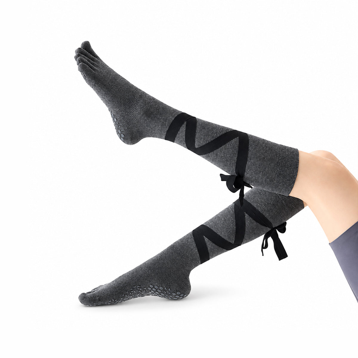 Non-slip, strappy, over-the-calf toe socks for yoga and Pilates.