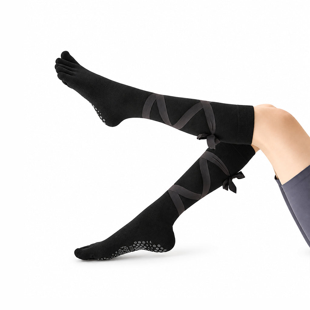 Non-slip, strappy, over-the-calf toe socks for yoga and Pilates.