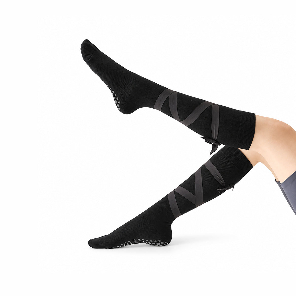 Non-slip, strappy, over-the-calf toe socks for yoga and Pilates.